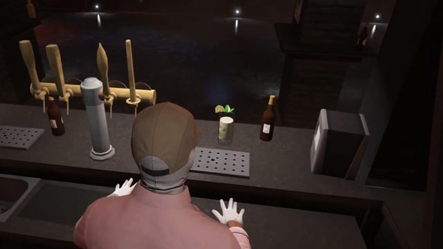 Player in a cap and pink jacket with both hands on a dark bar counter, facing a glass with a lime and mint garnish set on the counter between beer taps and two bottles.