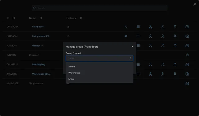 Manage group dialog for the Front door camera with a group list of Home, Warehouse and Shop.
