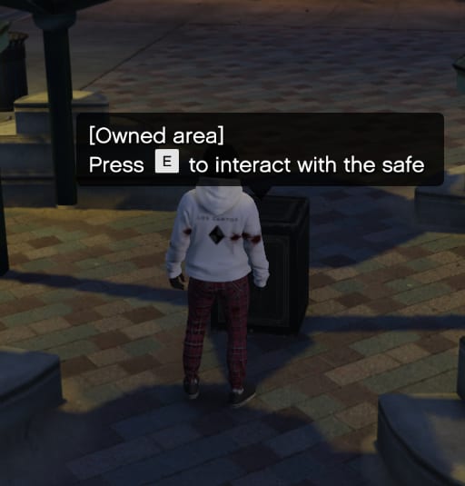 Player beside a safe with the prompt "[Owned area] Press E to interact with the safe".