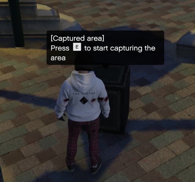 Player beside a safe with the prompt "[Captured area] Press E to start capturing the area".