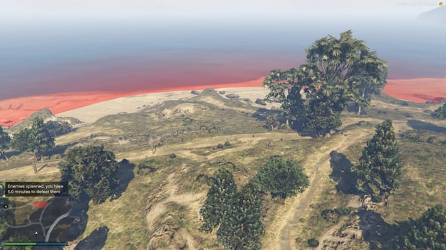 Aerial view of a coastal hillside with a red capture zone and a message that enemies spawned and there are 5.0 minutes to defeat them.