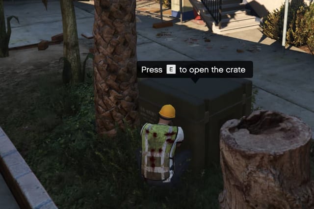 Player crouched beside a crate with the prompt "Press E to open the crate".