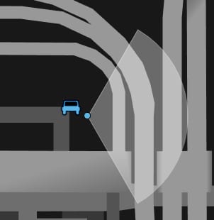 Map section with a blue vehicle icon and a light view cone on a road network.