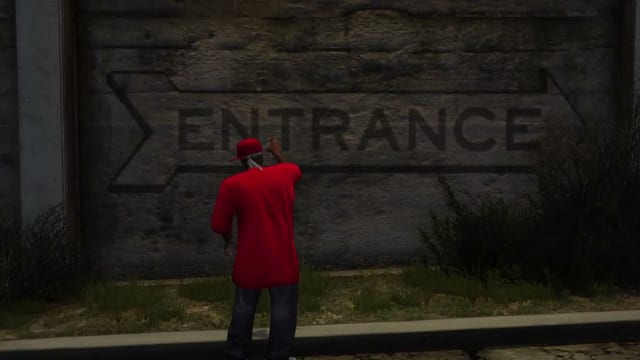 A player in a red shirt and cap raises a spray can at a concrete wall painted with the word Entrance, then a red Bloods tag appears on the wall above him.