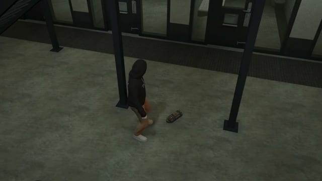 A hooded inmate crouches over an explosive on a prison floor and lights it, then walks away as orange smoke rises and it burns.