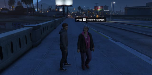 Player standing next to an NPC on a pavement at night with the prompt "Press E to rob the person".
