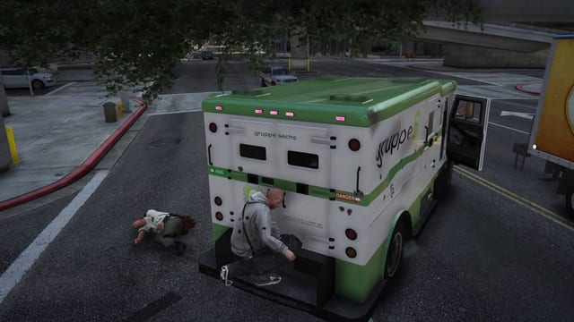 Player crouched at the rear doors of a green and white armoured bank truck on a city street, with a guard lying on the road beside it.